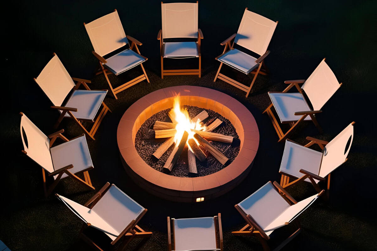 can-i-have-a-fire-pit-in-my-backyard-closing Image of a stone fire pit surrounded by folding chairs at night.