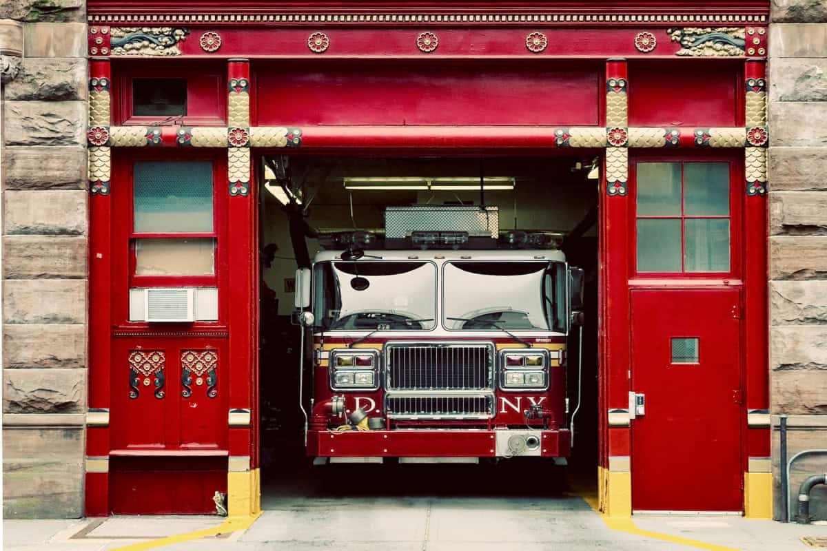 city-fire-pit-rules-need-to-know Image of a fire truck inside a city firehouse.