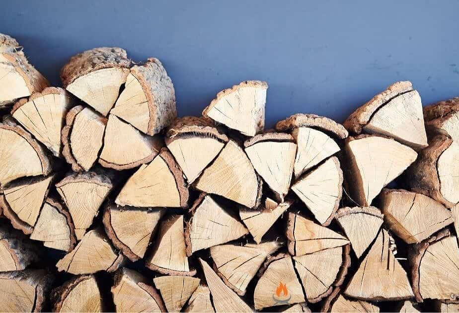 Image of a rick of wood stacked against a wall