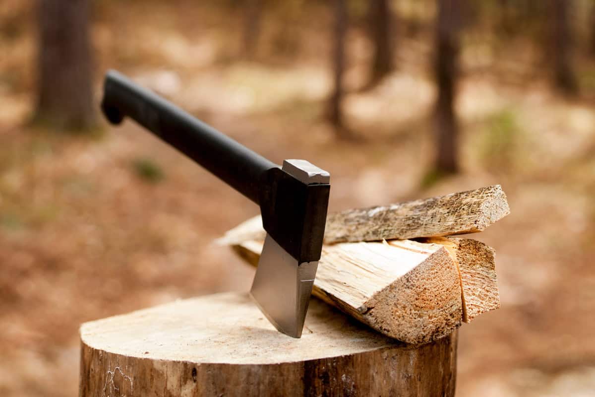Image of an axe stuck in a log.