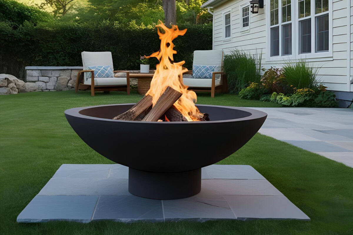 fire-pits-on-grass-protection Image of a burning fire pit bowl next to a patio.