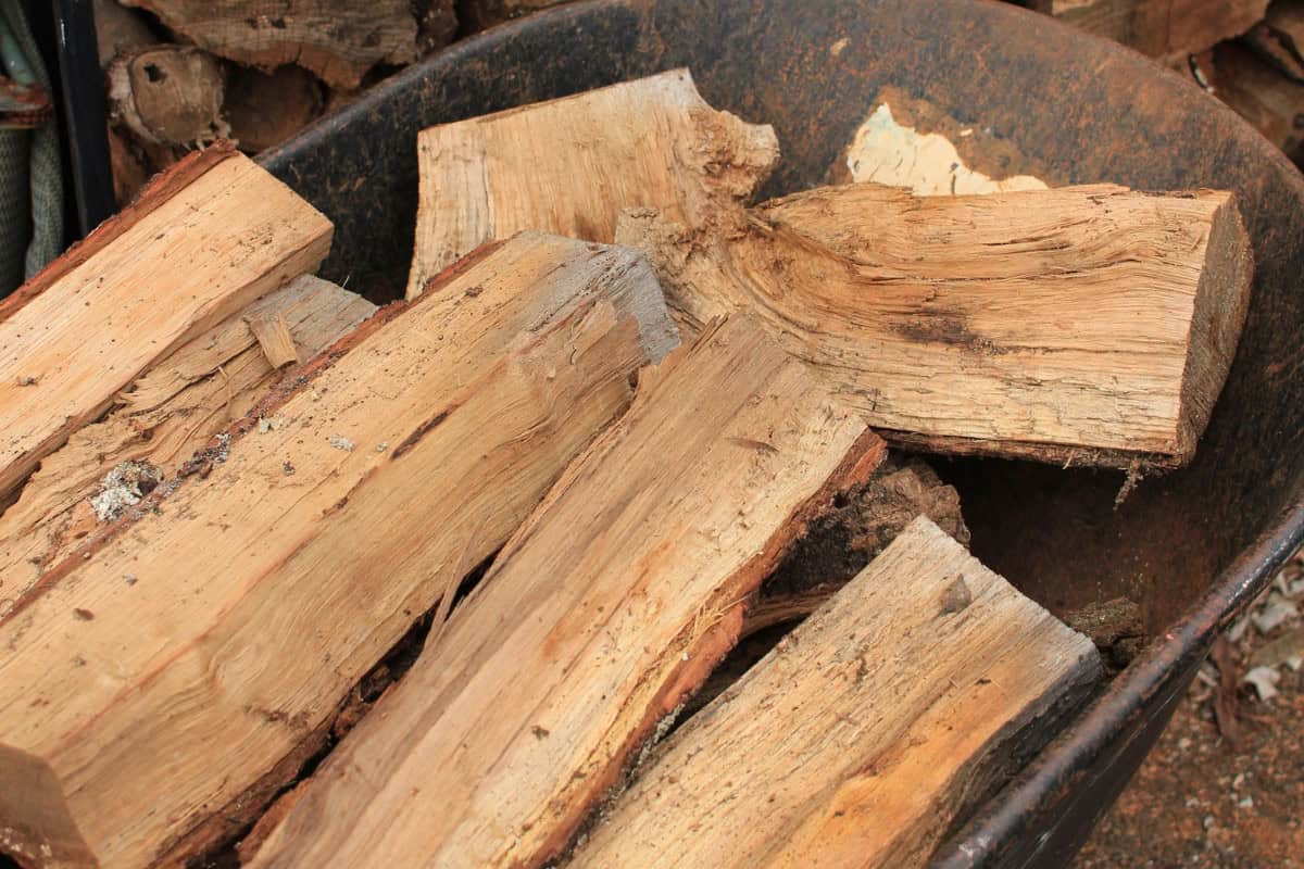 rick-of-firewood-sizes Image of several pieces of split wood in a wheelbarrow.