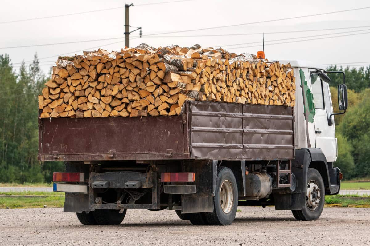 Assessing the Kiln-dried Firewood Supplier Image of a truck hauling a cord of firewood.