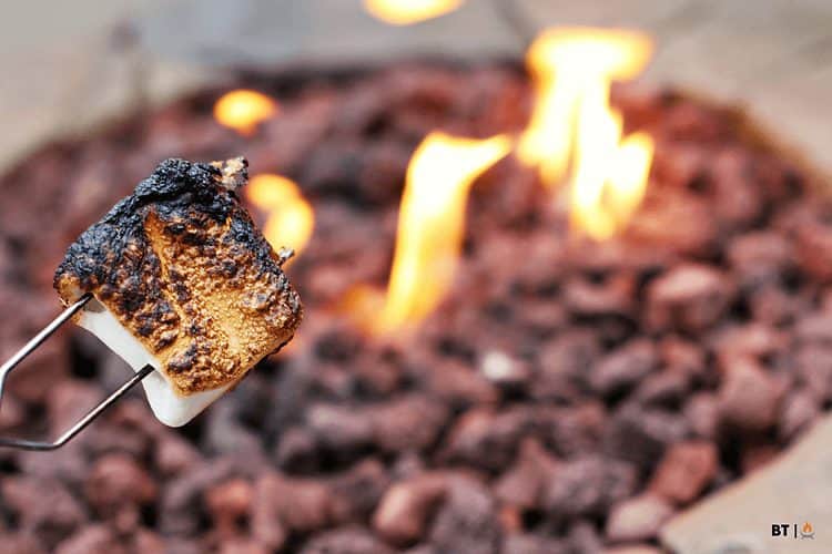 Image of a well roasted marshmallow in front of a propane fire pit