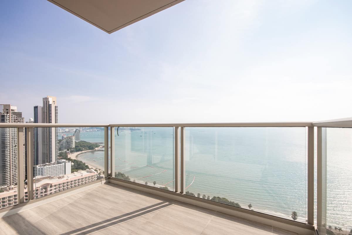 fire-pit-on-a-balcony-faqs Image of a high rise balcony overlooking water for a blog post about using a fire pit on a balcony.