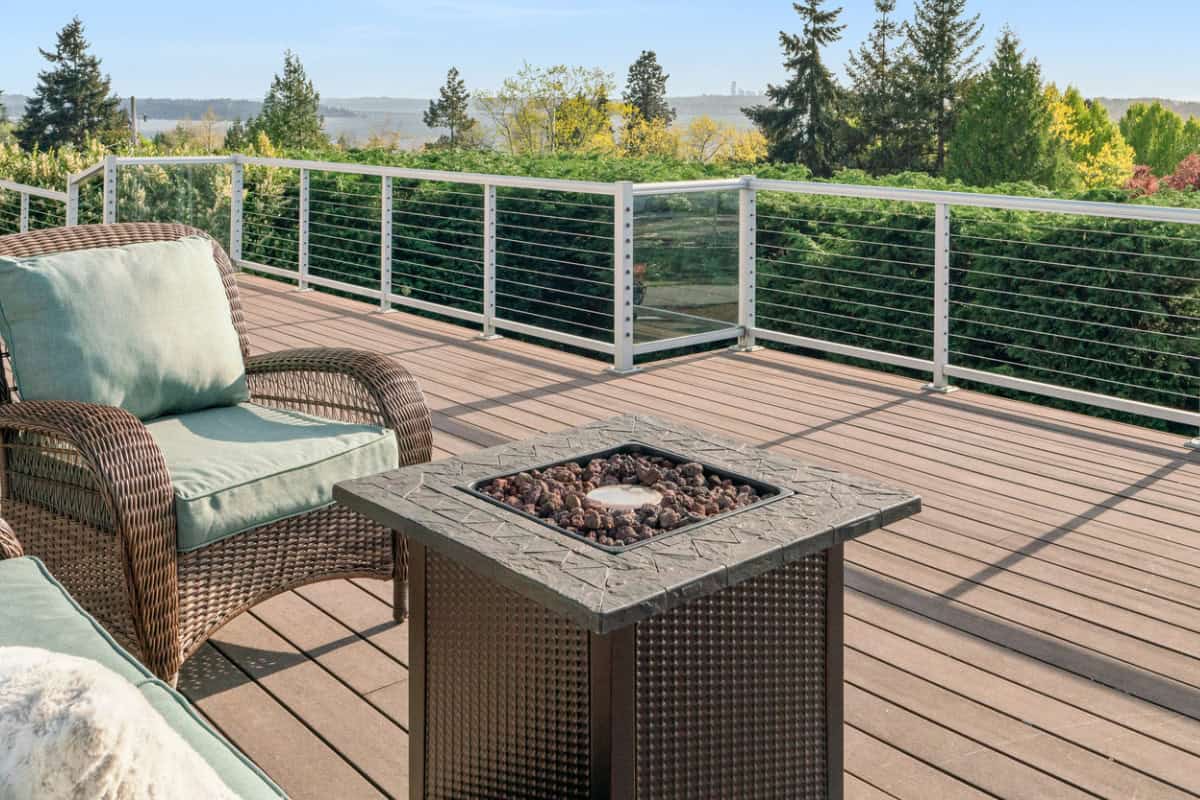 fire-pit-on-a-balcony-options Image of a square propane fire pit on a composite deck balcony.