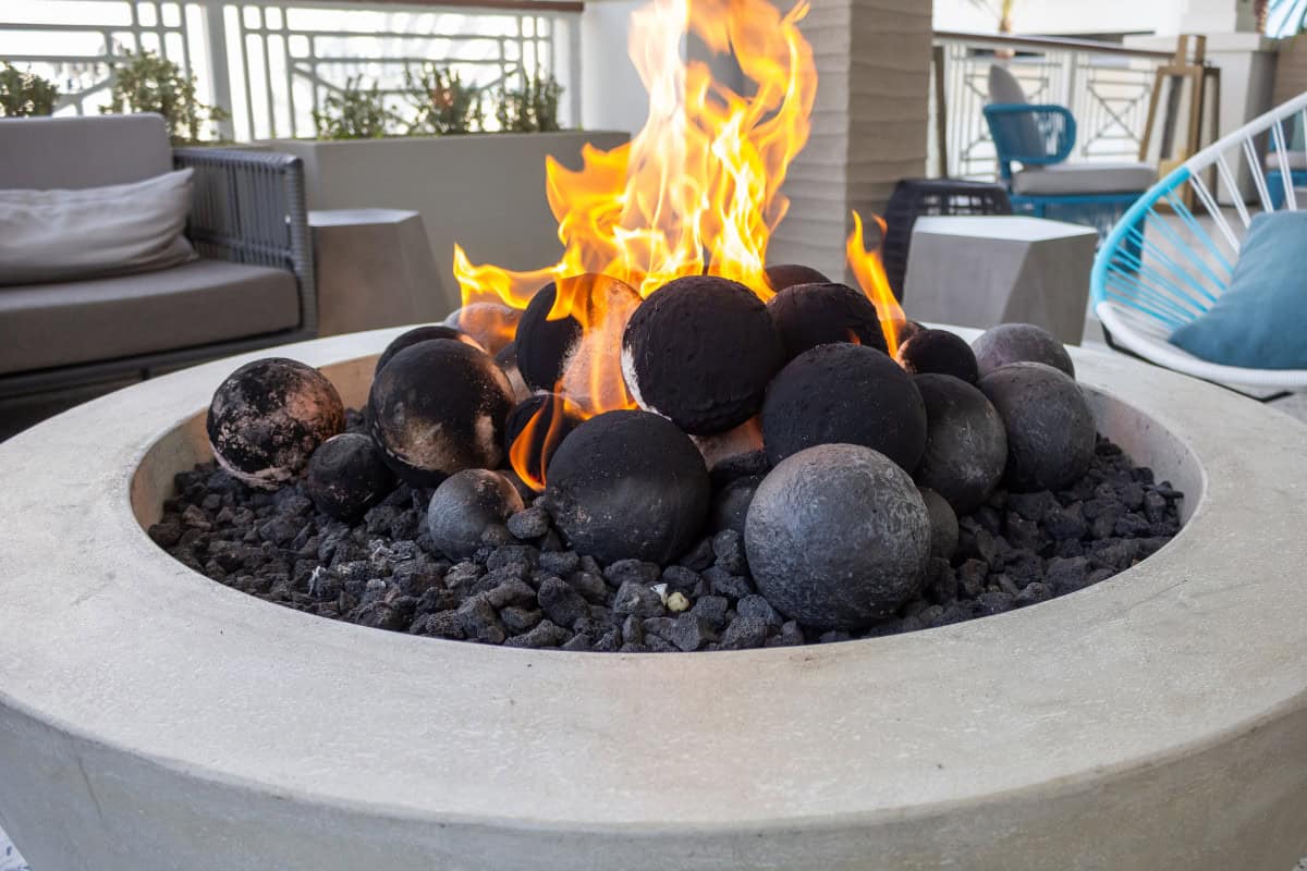 fire-pit-on-a-balcony-safety Image of a large gas fire pit bowl for a post covering the use of a fire pit on a balcony.