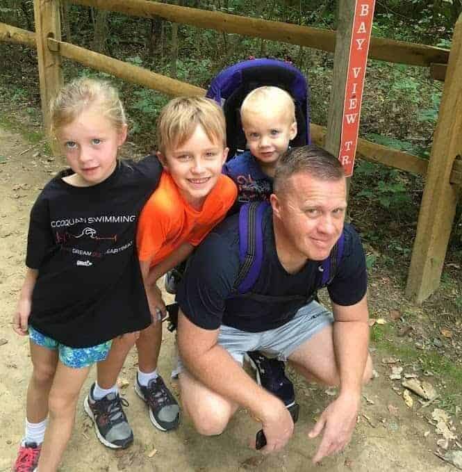 Image of dad and kids on trail hike