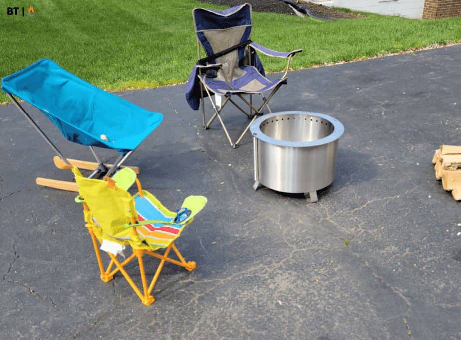 Image of a fire pit and chairs on a driveway