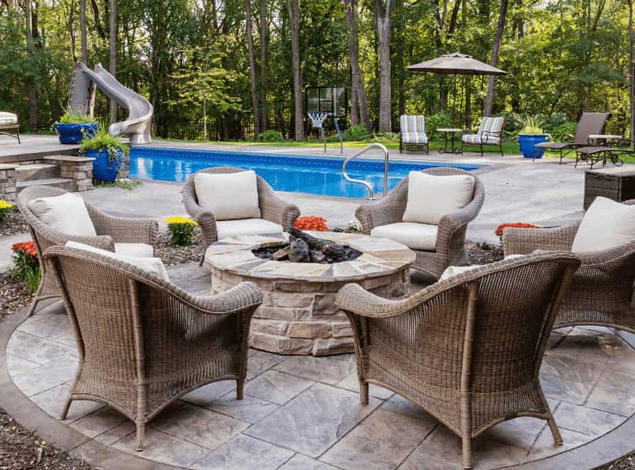 Image of a fire pit and seating set near a swimming pool