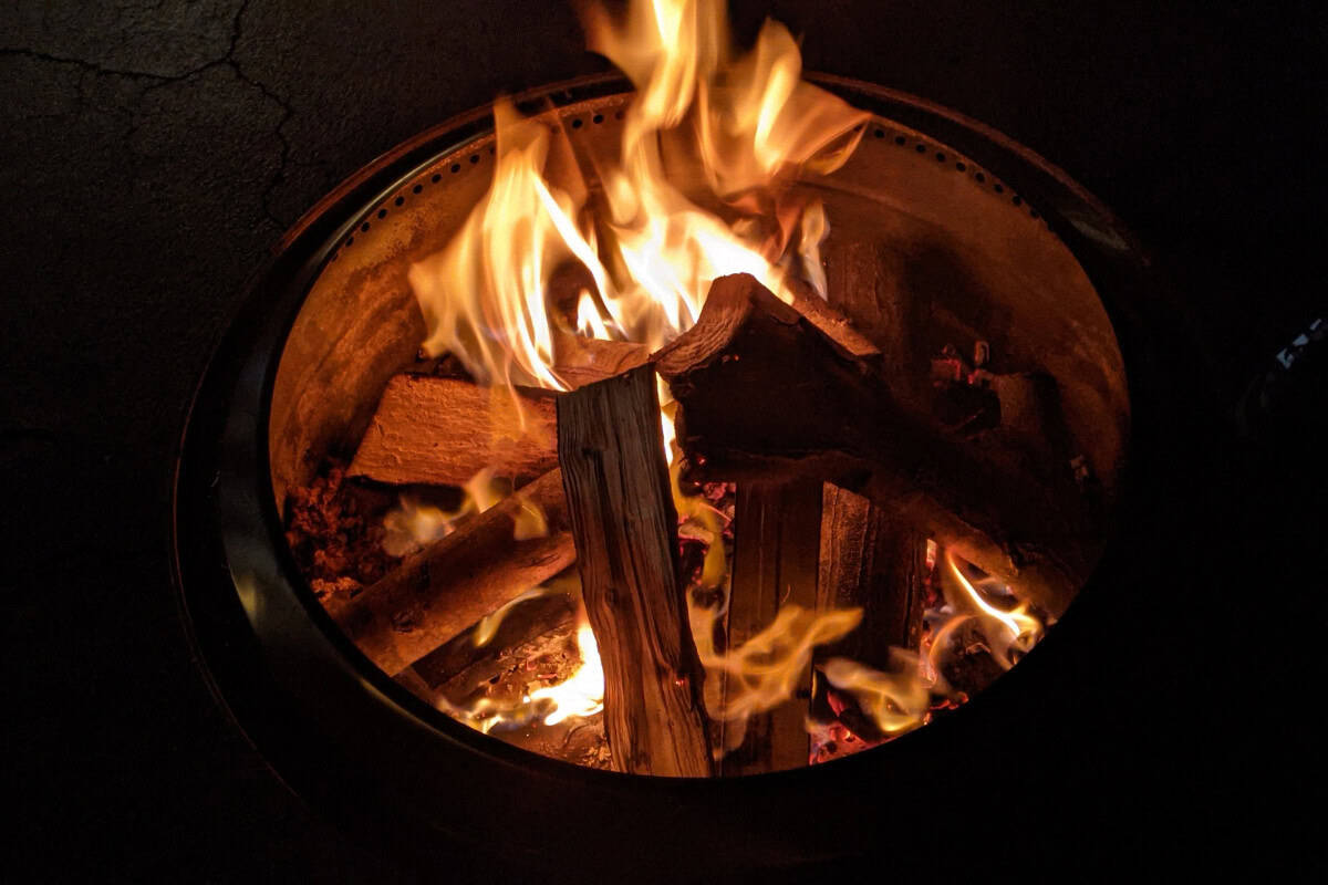 solo-stove-on-composite-deck-main Image of a smokeless fire pit burning at night for a blog post about using a solo stove on a composite deck.