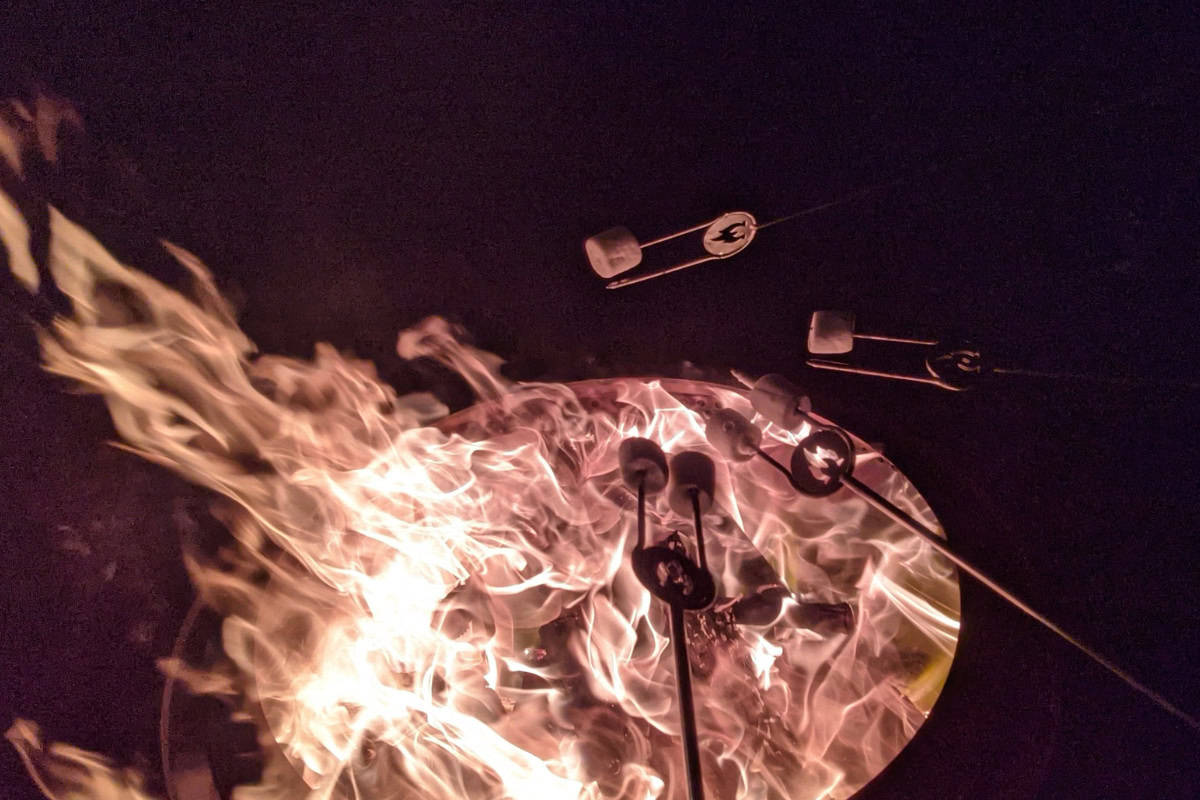 fire-pit-benefits-closing Image of marshmallow roasting over fire pit at night.