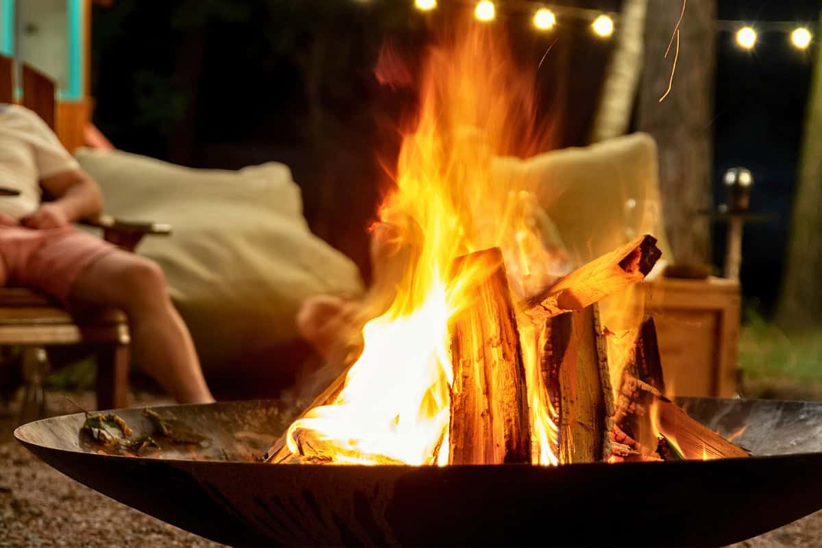 fire-pit-benefits-main Image of a fire pit bowl burning at night for a blog post covering the benefits of a fire pit.