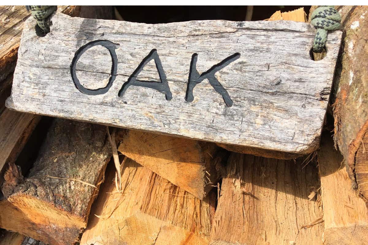 seasoned-firewood-types Image of a stack of oak wood for sale.