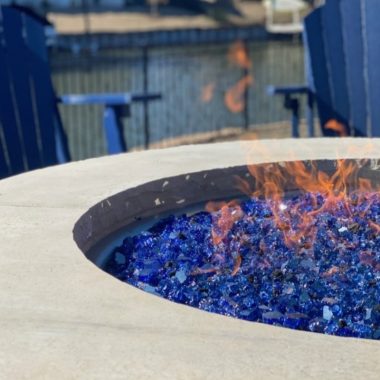 Image of a gas fire pit with blue glass for an article covering fire pit glass.