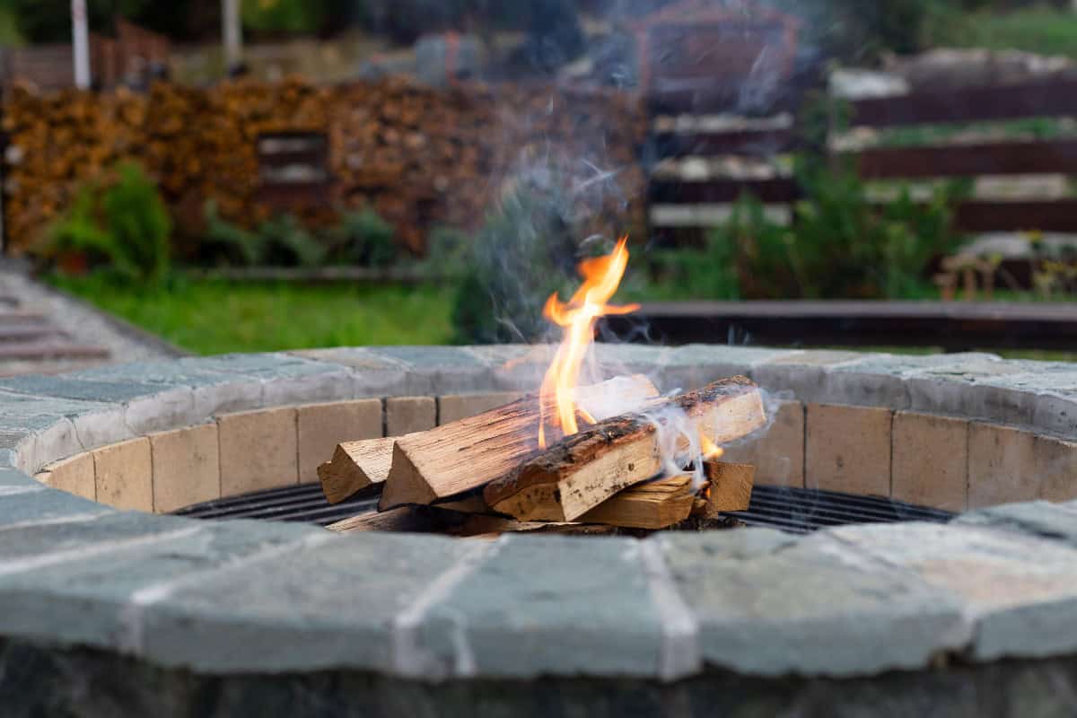 is-a-fire-pit-open-burning-closing Image of a freshly started wood-burning fire pit.