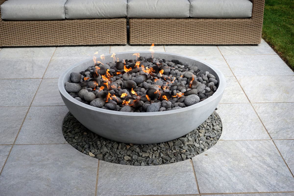 Understanding 'Good Size' Fire Pit Dimensions Image of a natural gas fire pit bowl on a hardscape patio.