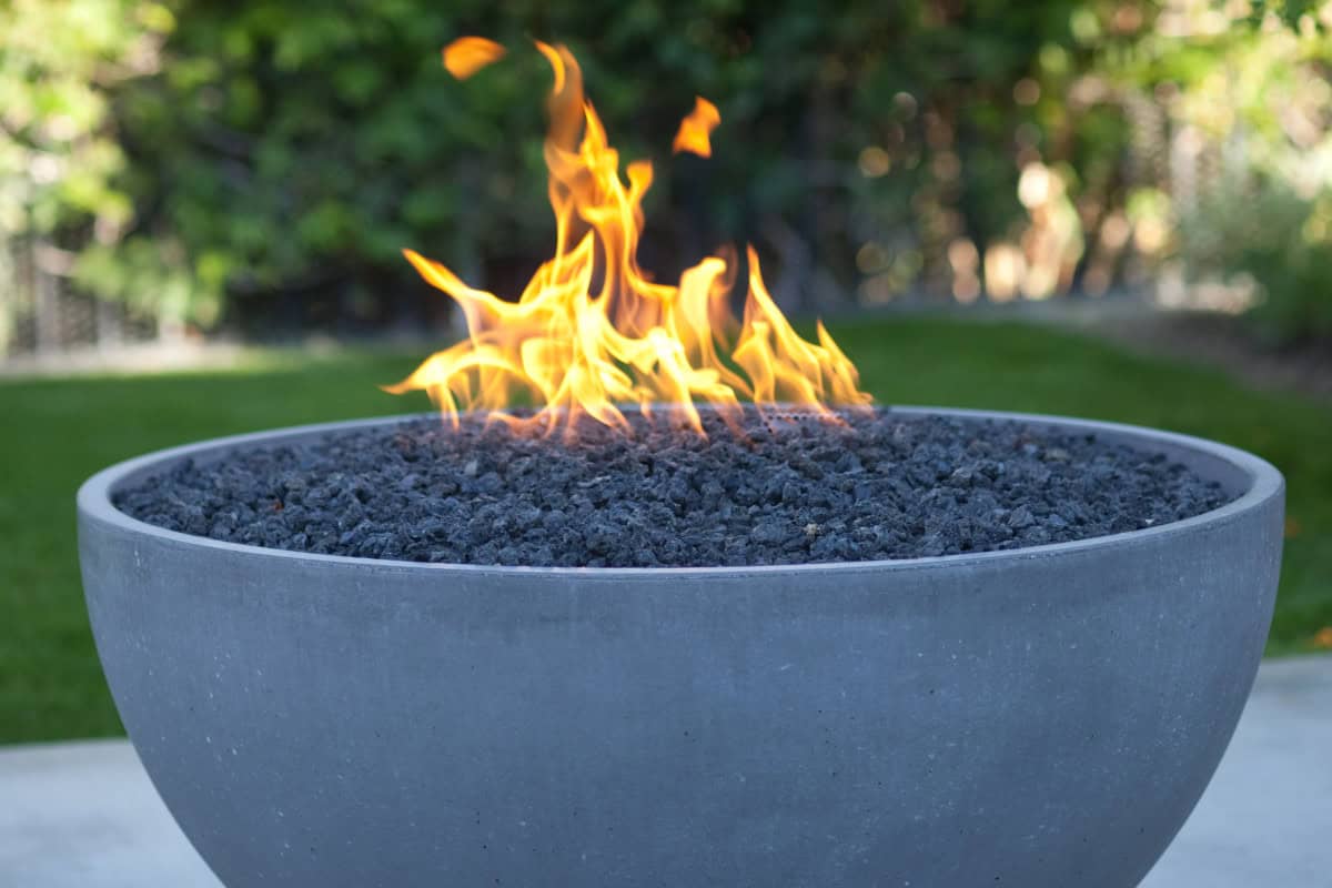 gas-fire-pits-provide-heat-limitations Image of a burning gas fire pit bowl for a blog post answering the question, "do gas fire pits produce heat?"