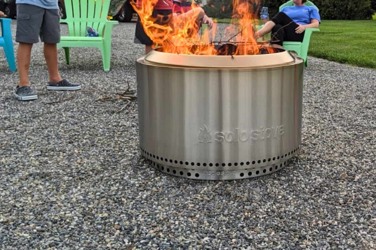 what-size-solo-stove-yukon Image of a smokeless fire pit on a gravel driveway.