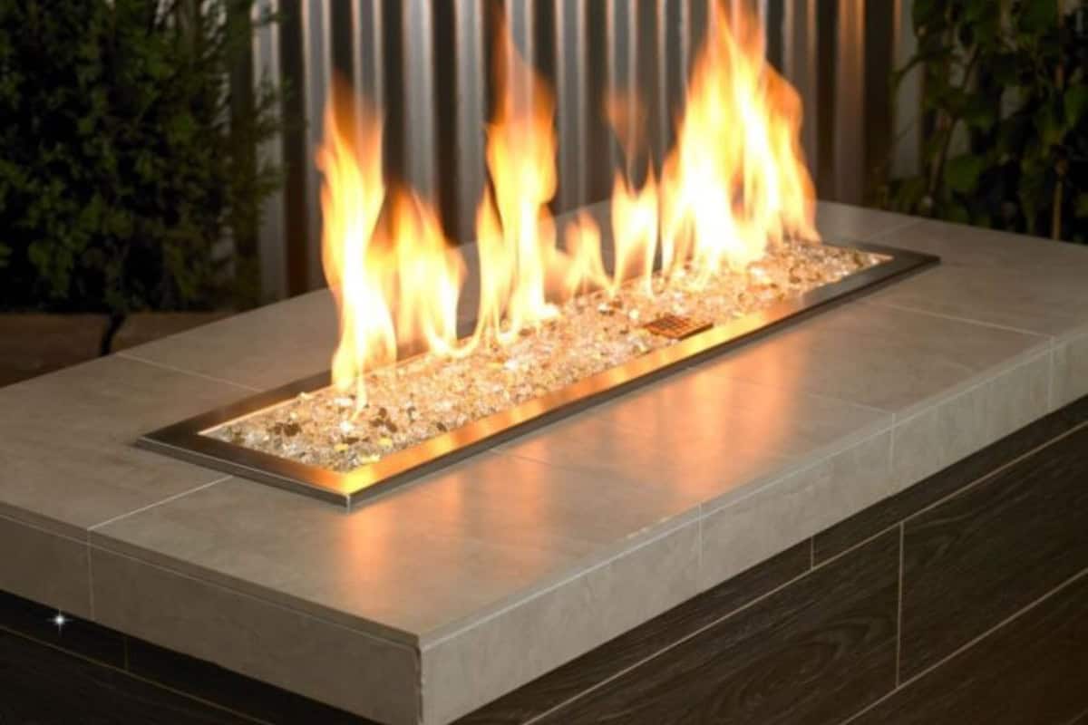 fire-pit-media-main Image of a rectangular gas fire pit with clear fire glass for a blog post about fire pit media.