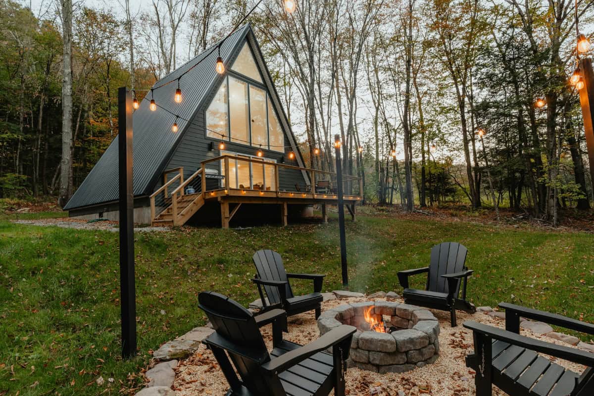 Image of a masonry fire pit slightly downhill form a home as an example of fire pit clearance requirements compliance..