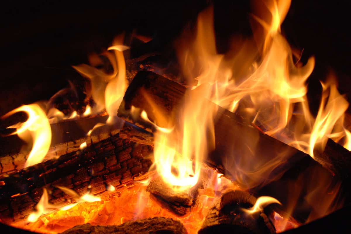 what-are-hardwoods-closing Image of a well burning fire at night for a blog post answering the question, "what are hardwods?"