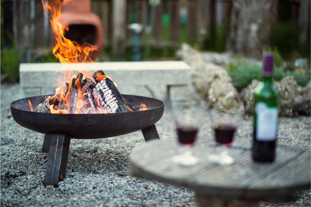 uk-firewood-prices-demand Image of a fire pit and table in a backyard.